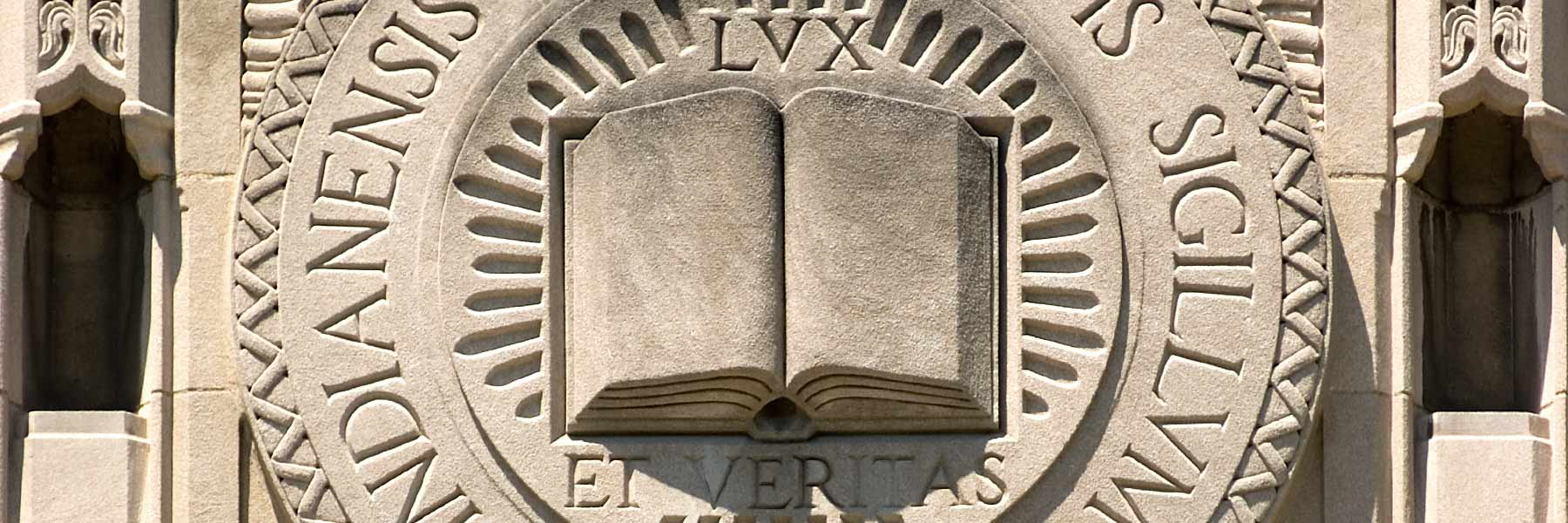 An elaborately-carved IU seal on a historic building