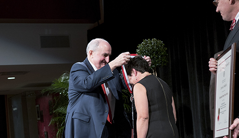 IU President Michael A. McRobbie presents the Distinguished Alumni Service Award to the Hon. Lorn...