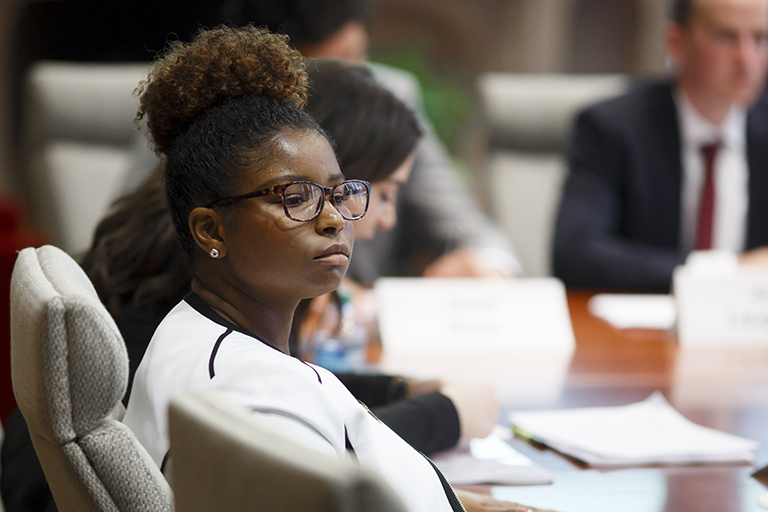 Board of Aeons member Sidney Harris listens as her peers deliver their final presentations.