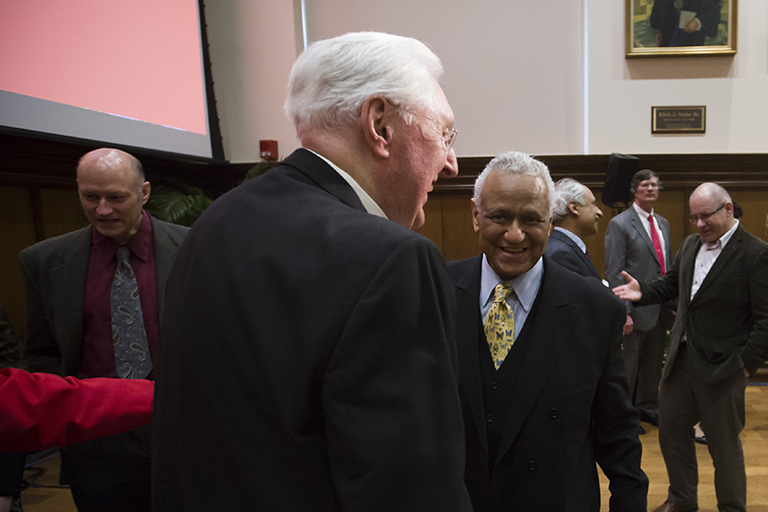 Faculty and their guests mingle in Presidents Hall after the symposium, inside Franklin Hall on t...