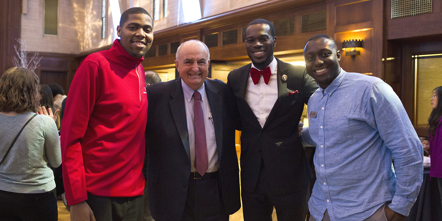 President McRobbie poses with IU employees at the winter holiday open house for faculty and staff...