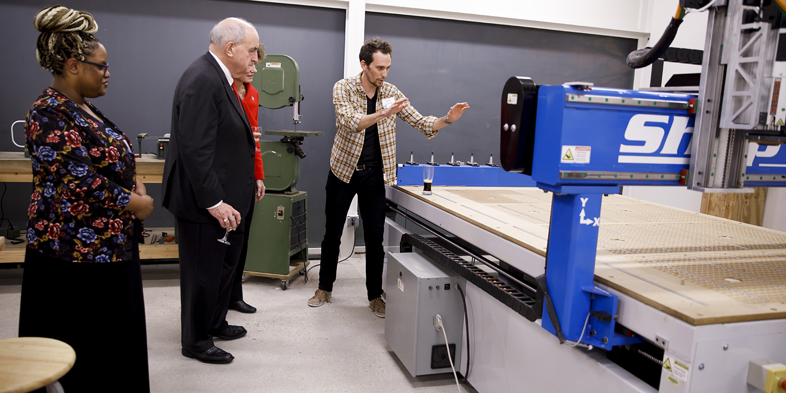 IU President McRobbie listens as a student shows him how a machine works