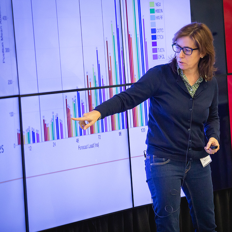 Sergi Girona points to a chart on a large screen