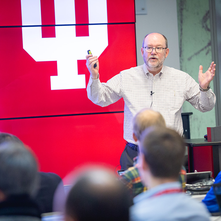 Dan Reed speaks in front of large screen