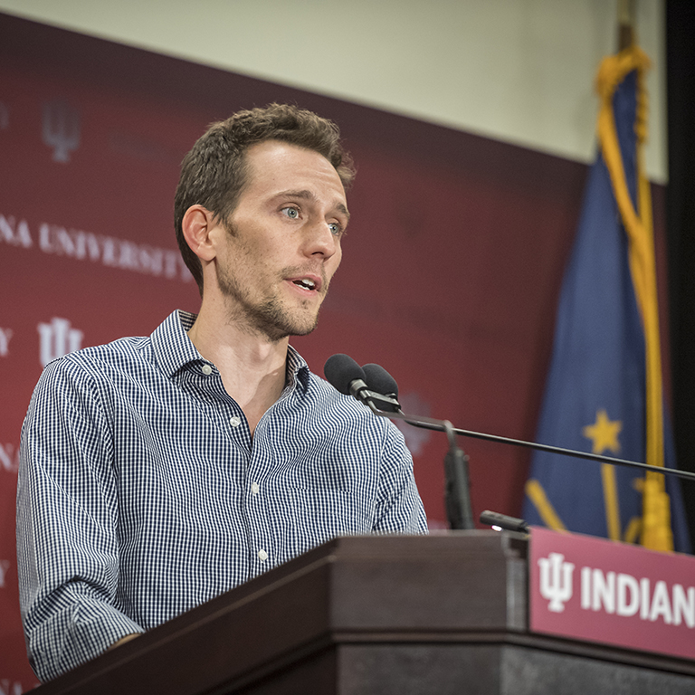 IU student Jacob Bower-Bir speaks into a microphone