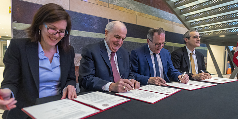 Indiana University Vice President for International Affairs Hannah Buxbaum, IU President Michael A. McRobbie, Sorbonne University President Jean Chambaz and Sorbonne University Vice President for International Development Serge Fdida sign partnership agreements at a table.