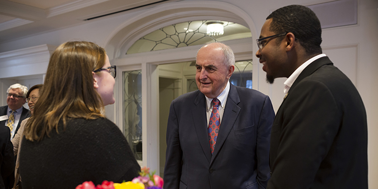 IU President McRobbie talks with two students