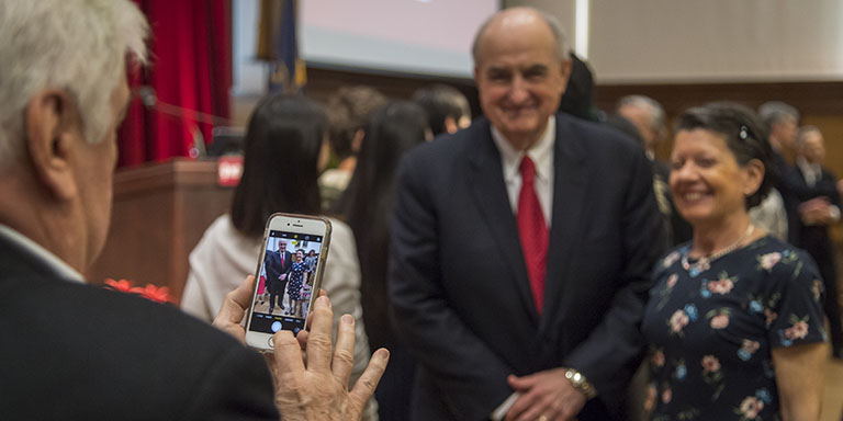 Someone takes a mobile photo of IU President McRobbie with Consul-General of Brazil in Chicago Ambassador Maria Winkler 