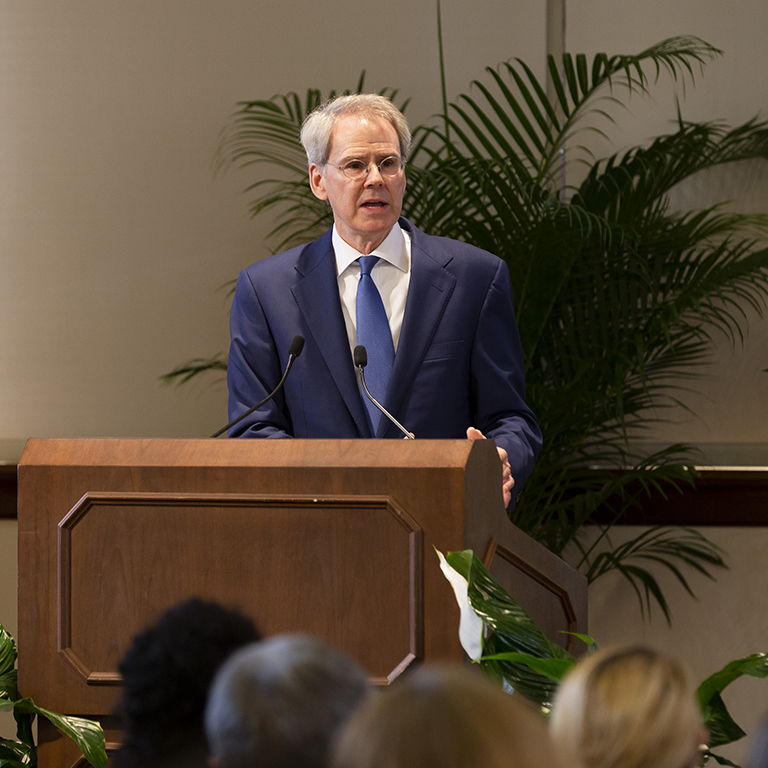 David Carden speaks from a podium