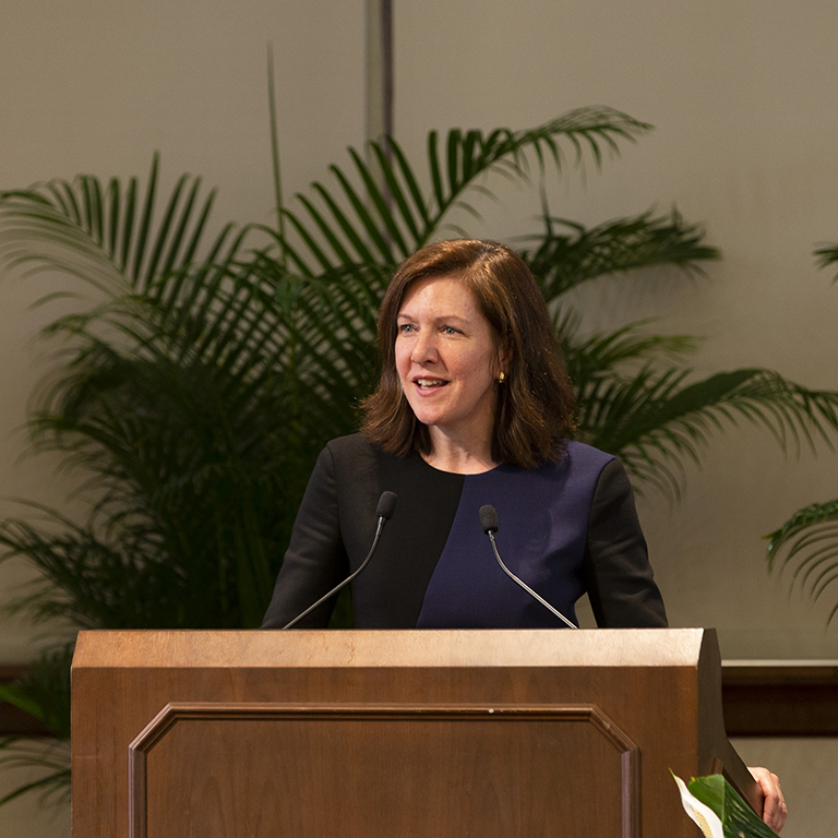 Hannah Buxbaum speaks from a podium