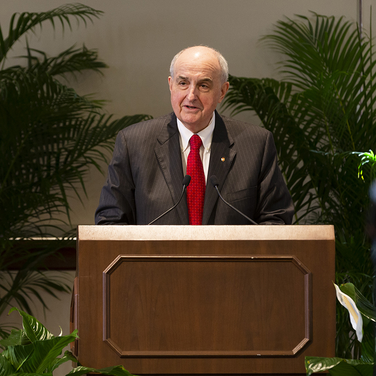 IU President McRobbie speaks from a podium