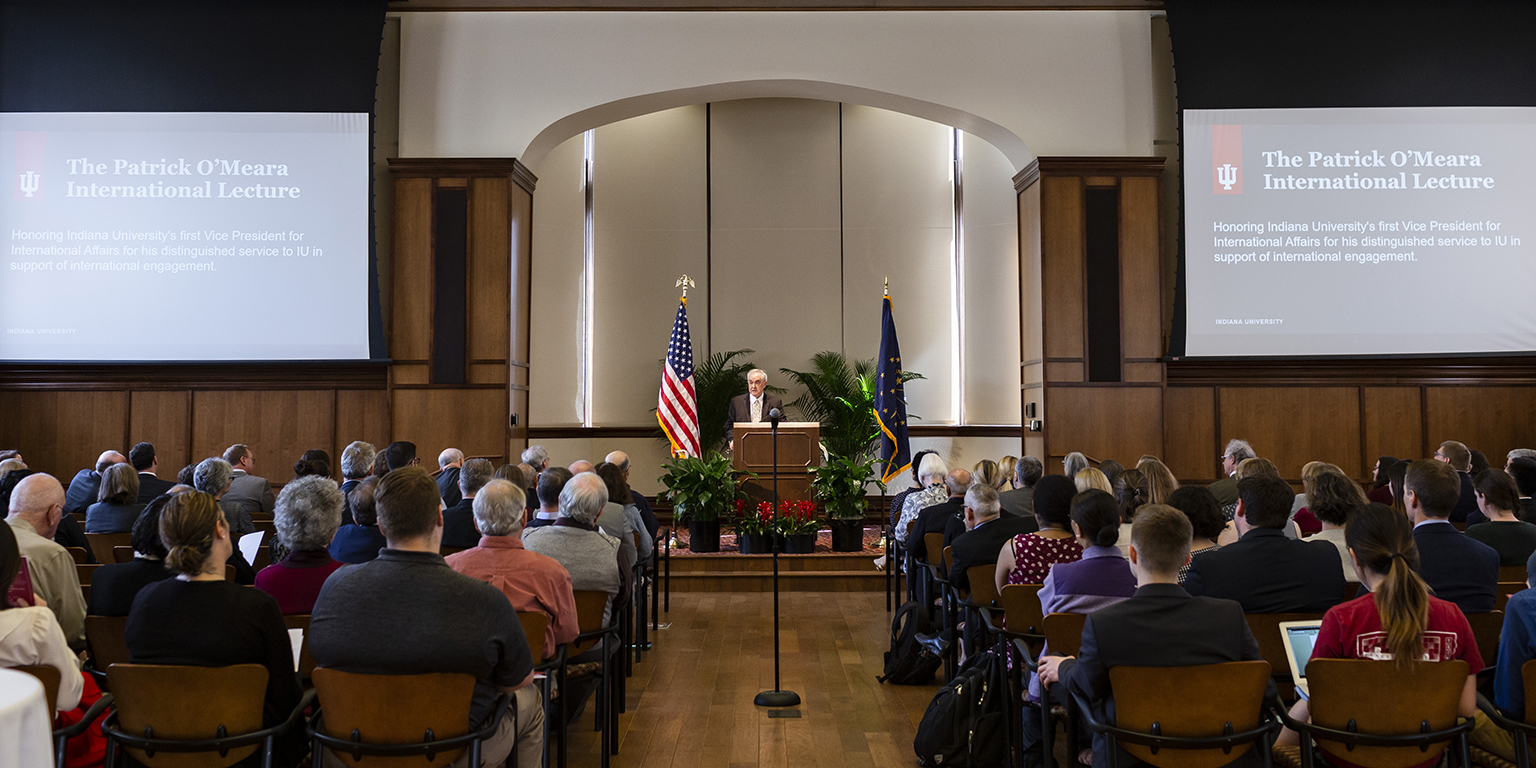 Patrick O'Meara stands in front of a room full of seated people