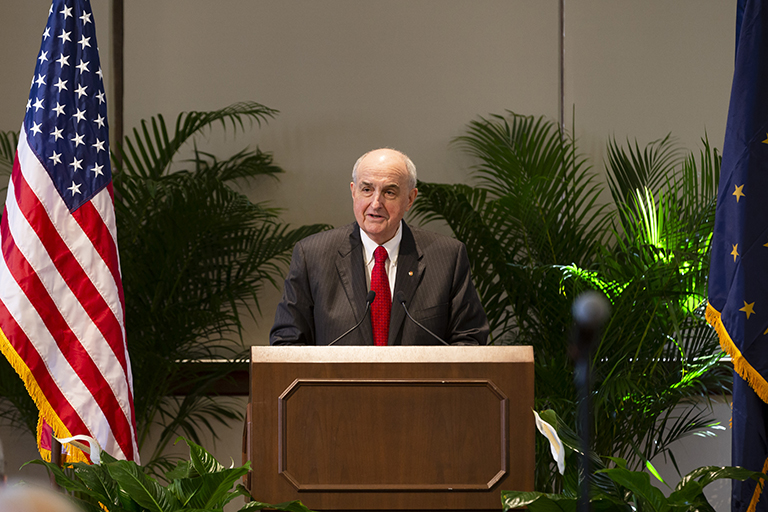 IU President McRobbie speaks from a podium