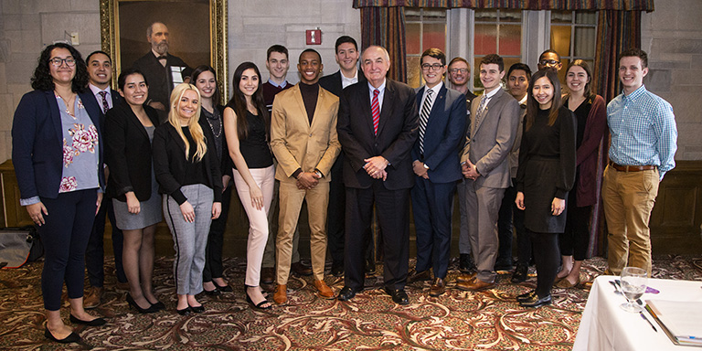 A group photo of students with IU President McRobbie