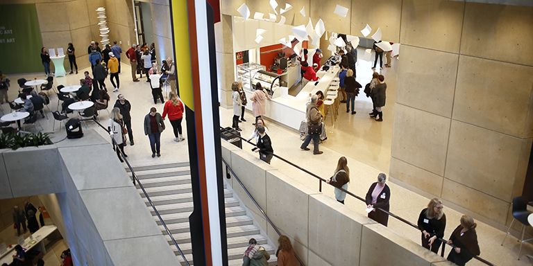 People walk around the Eskenazi Museum of Art