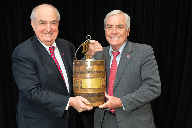 IU President McRobbie and IU Board of Trustees Member Michael Mirro hold the Oaken Bucket