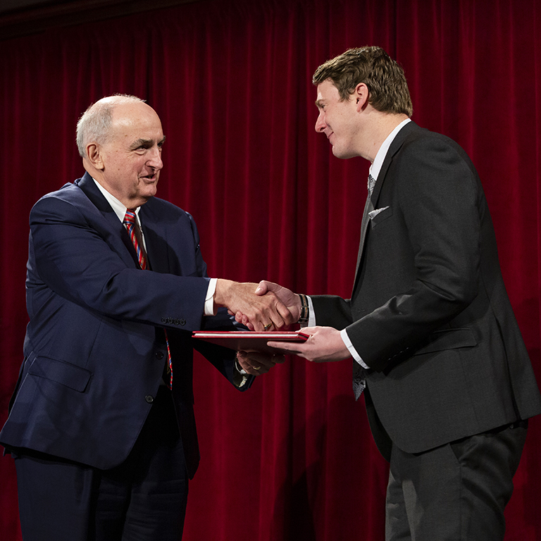 IU President McRobbie shakes hands with award recipient Michael Karlin